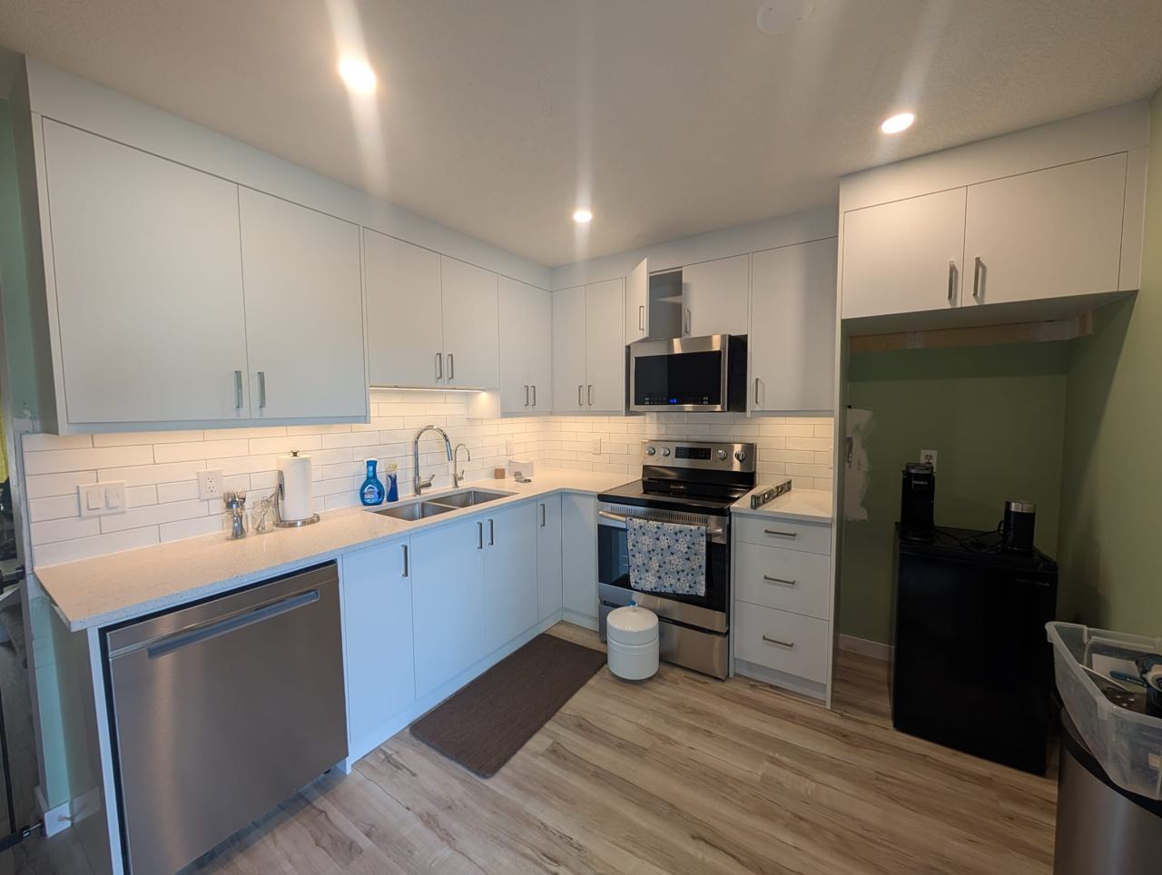Finished kitchen with pot lights and under-cabinet lighting